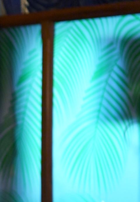 Illuminated palm-frond screen in the reception hall.